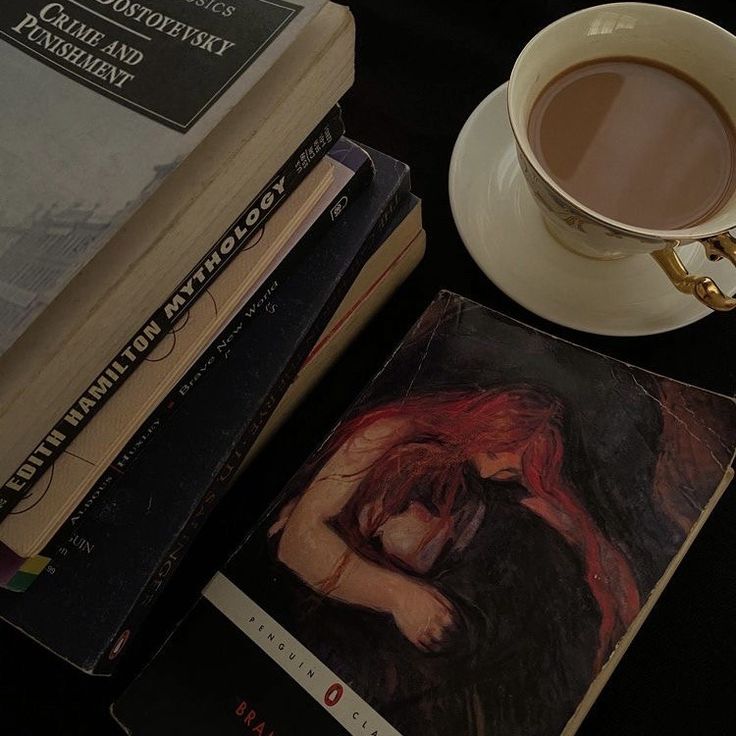 a stack of books next to a cup of coffee