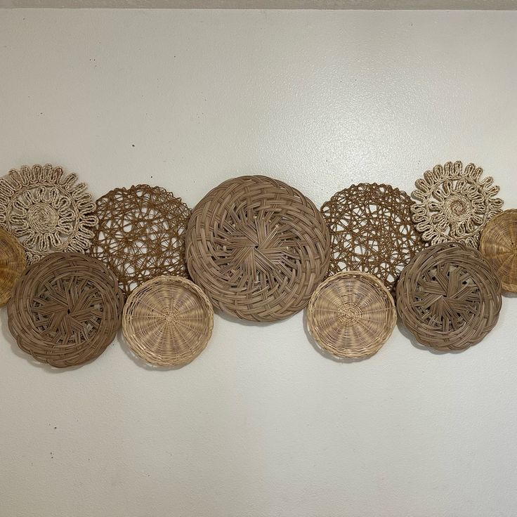 a group of decorative plates sitting on top of a white wall