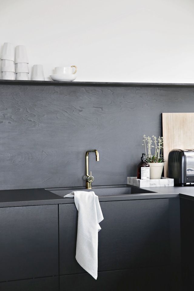 a kitchen sink with a towel hanging from it's side and a counter top in front of it