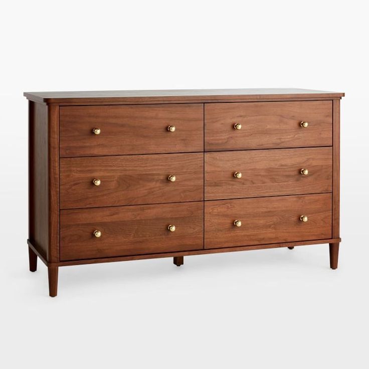 a wooden dresser with brass knobs on the top and bottom drawers, against a white background