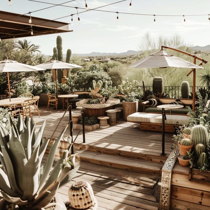 an outdoor patio with cactus and potted cacti on the deck, surrounded by greenery