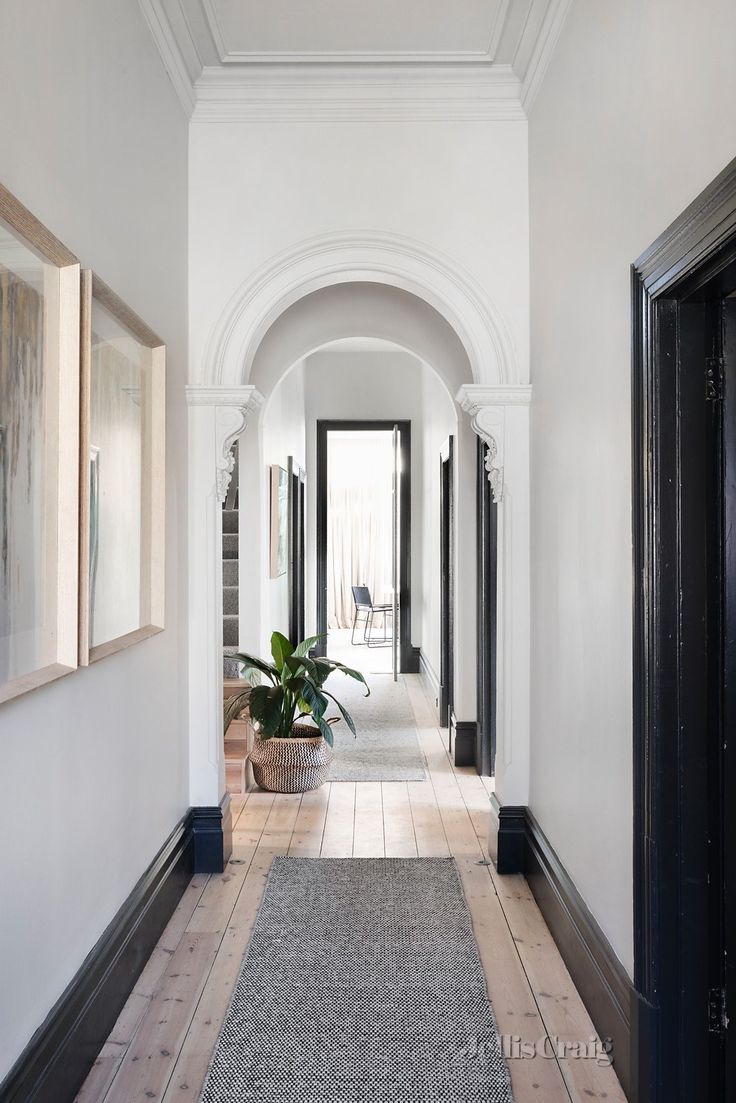 the hallway is clean and ready for us to use as an entrance way in this home