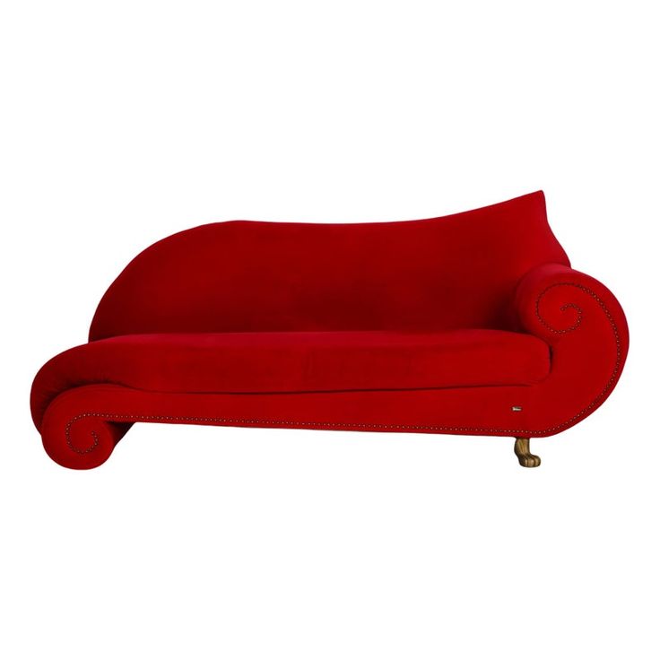 a red couch sitting on top of a white floor