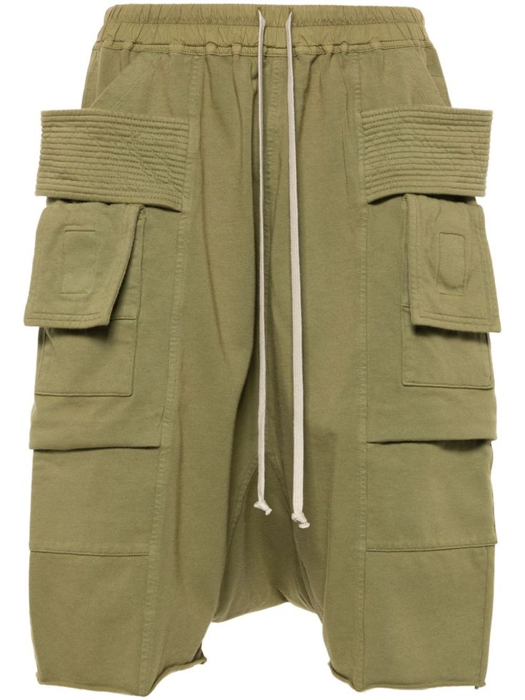 sage green organic cotton elasticated drawstring waistband layered details two side pouch pockets two side cargo pockets drop crotch two rear flap pockets below-knee length This item is made from at least 50% organic materials. Learn more about what makes a product Conscious on our Conscious Criteria page City Shorts, Rick Owens Drkshdw, Organic Materials, Balenciaga Triple S, Custom Watch, Summer Beach Wear, Sweaters Knitwear, Drawstring Waistband, Light Jacket