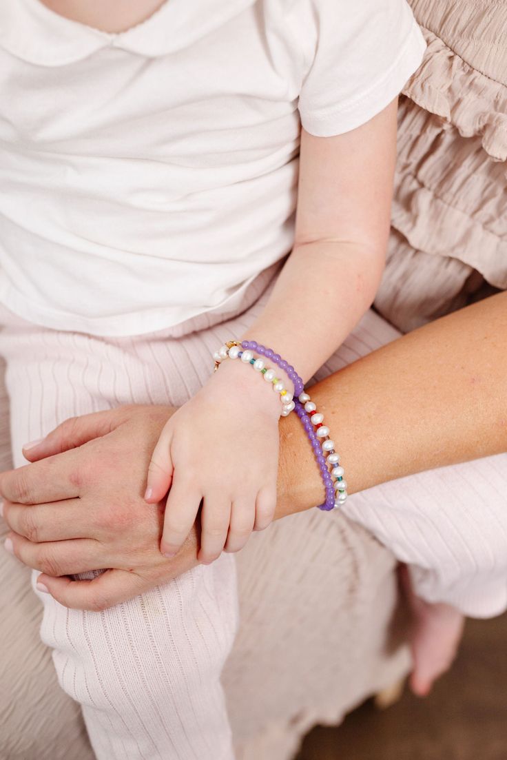 A little fun + a little fancy. Whimsy is a blend of sophisticated creamy pearls + tiny rainbow seed beads making it 100% dreamy to add into your wardrobe. The perfect accessory for every Mom + her mini! Made with the highest quality materials, this bracelet will look beautiful for years to come. Durable enough for play, precious enough to keep forever. Materials: 14k gold filled or sterling silver components. Nickel free. To learn more about our materials and what makes gold filled unique read here. Features: Each bracelet has a ½” extender chain to allow it to grow with your child. Guarantee: 100% satisfaction guaranteed. If you don’t love it, contact us to arrange a return/exchange. Read more about our quality guarantee here. PLEASE WATCH TEETHING BABIES CAREFULLY AS SMALL COMPONENTS CAN Adjustable Beaded Pearl Bracelets With Pearl Charm, Adjustable Beaded Pearl Bracelet With Pearl Charm, Dainty Adjustable Beaded Bracelets With Pearl Charm, Dainty Adjustable Pearl Beaded Bracelets, Dainty Pearl Beaded Adjustable Bracelets, Adjustable Pearl Bracelet With Tiny Beads, Adjustable Beaded Bracelets With Pearl Charm For Everyday, Dainty Pearl Beaded Bracelets With Spacer Beads, Adjustable Pearl White Jewelry With Colorful Beads