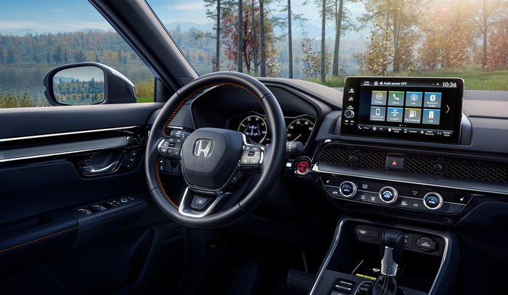 the interior of a car with dashboard, steering wheel and touchscreens on display