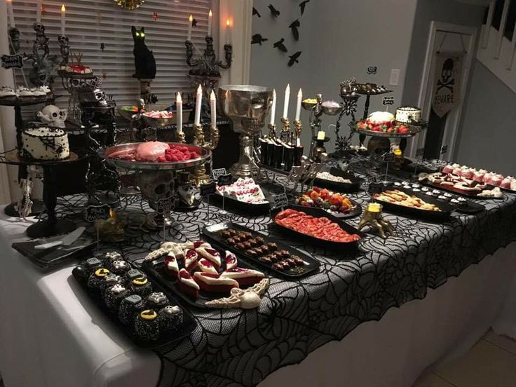 a table topped with lots of different types of foods and desserts on top of it