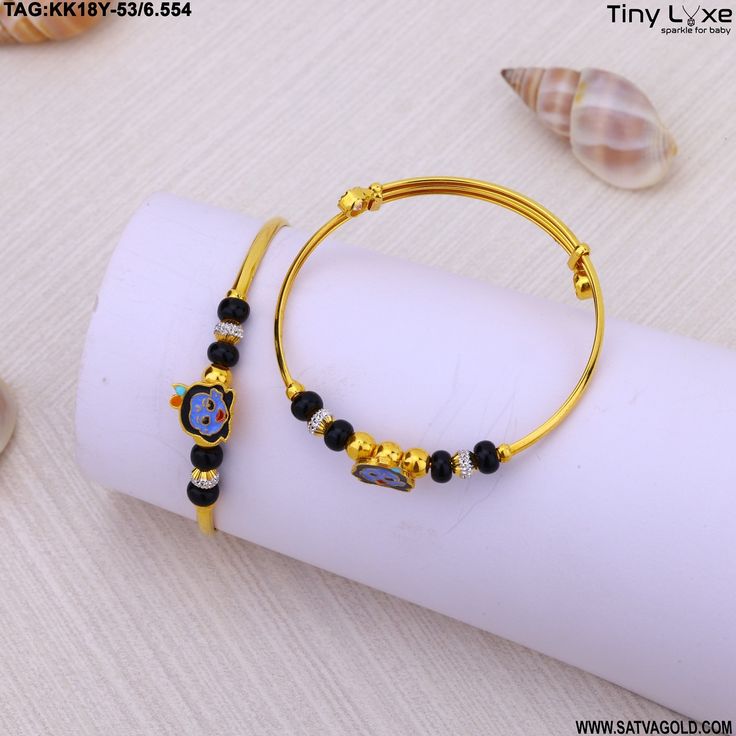 two gold bracelets with black beads and charms