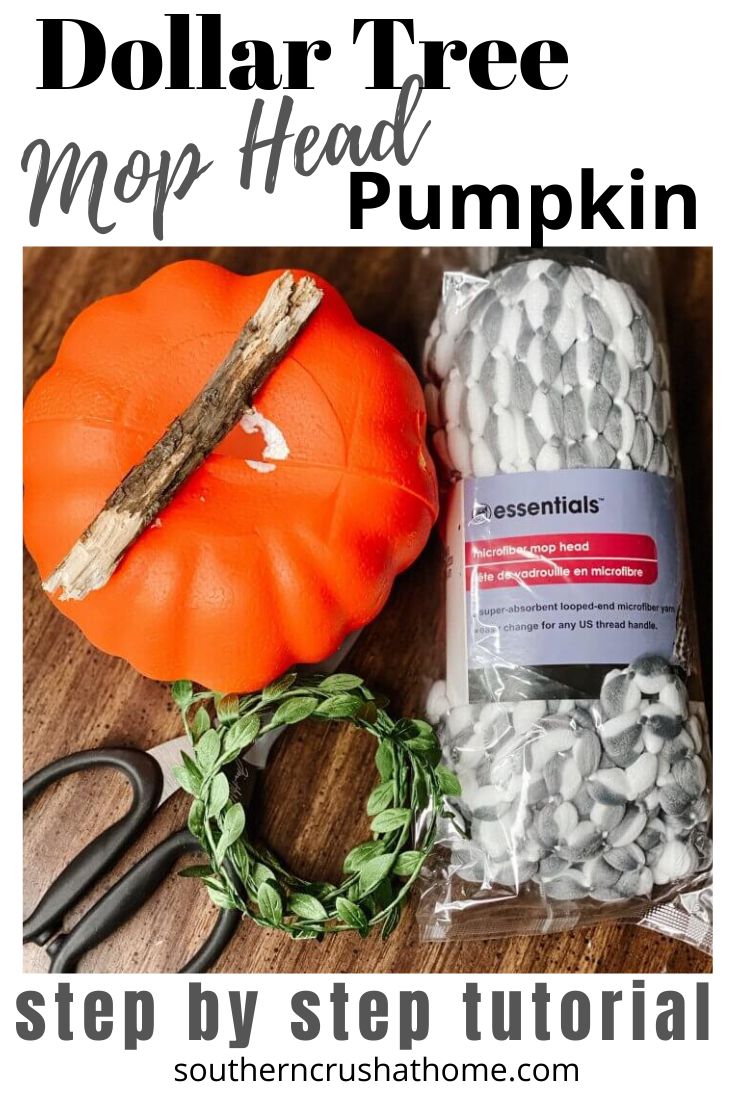 the dollar tree mop head pumpkin is sitting on top of a cutting board with scissors