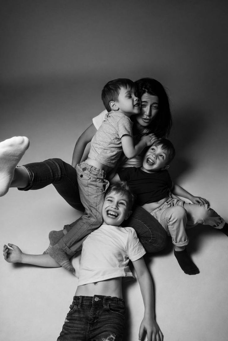 a group of children laying on top of each other in the middle of a photo