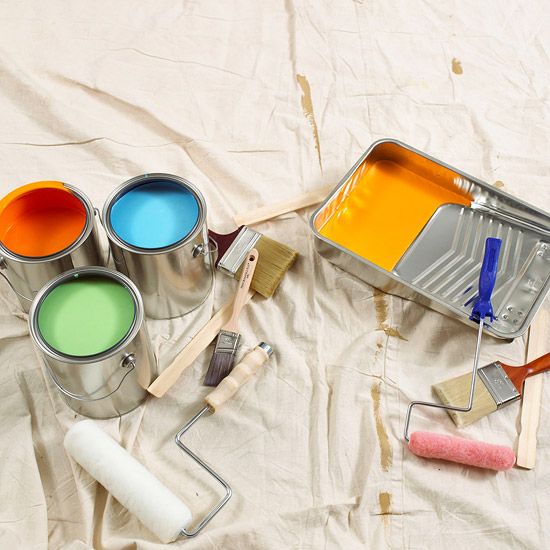 several paint cans with different colors and brushes