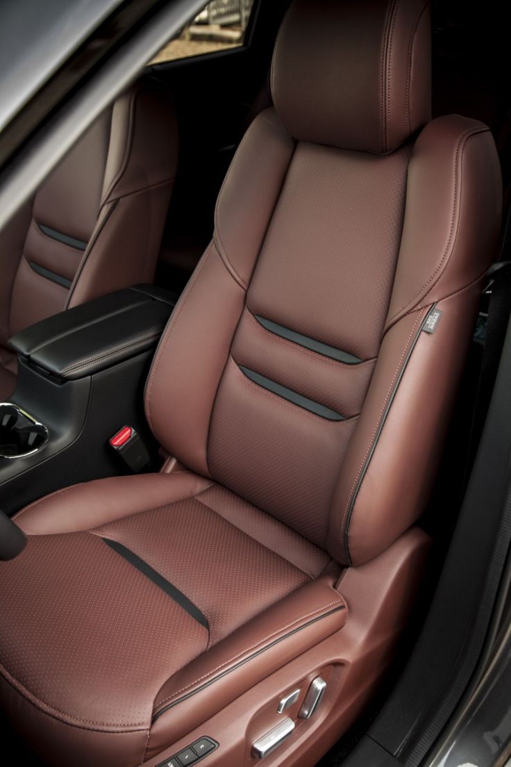 the interior of a car with brown leather seats