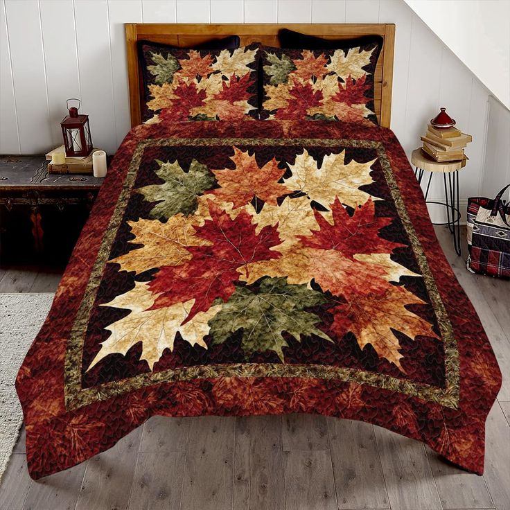 a bed covered in a red and gold quilted comforter next to a wooden headboard