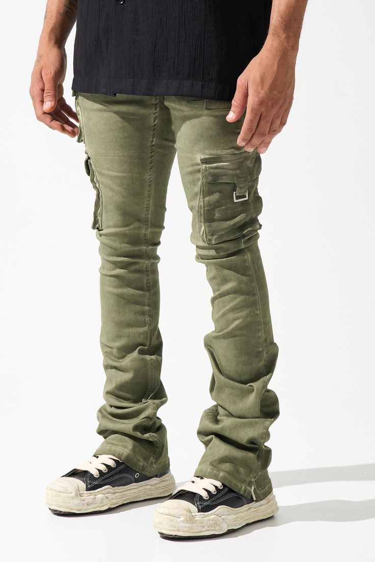 SERENEDE® "OIL" cargo stacked jeans feature our signature stretch material for a comfortable feel. Olive wash* with a slight tint of green. SERENEDE® signature skinny fit construction with a stacked ankle. This unique style features multiple cargo pockets. Designed to be individually unique. DETAILED FEATURES: OLIVE wash [ slight tint of green ] Cargo pockets Stacked finish Fading throughout Signature "leather" waistband label SERENEDE® branded hardware Five-pocket styling Zipper fly 5.5" W Ankl Military Cargo Style Jeans For Streetwear, Fitted Khaki Cargo Pants For Streetwear, Urban Green Cargo Bottoms, Green Military Cargo Jeans, Olive Military Cargo Pants For Streetwear, Military Style Olive Cargo Pants For Streetwear, Military Style Straight Leg Cargo Jeans For Streetwear, Straight Leg Military Cargo Jeans For Streetwear, Khaki Cargo Style Jeans For Streetwear