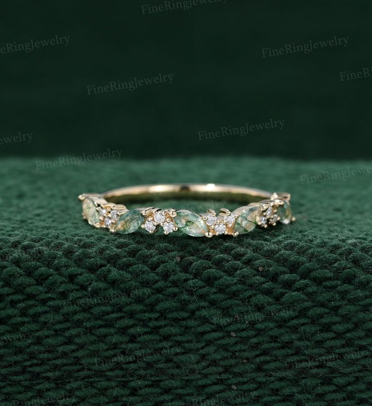 an image of a wedding ring with green stones