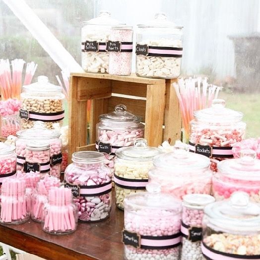 a table filled with lots of pink and white candy