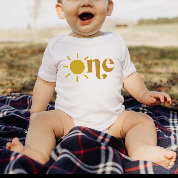 Celebrate your little one's first trip around the sun in style with our Sun in One 1st Birthday Bodysuit! Perfect for a sunshine theme first birthday, you can complete the look with matching tees for the whole family! And with its 100% combed ringspun cotton and light fabric, it’ll feel almost like baby’s been wearing it forever! (Almost as long as they’ve been around the sun!) Sun Onesie, Sunshine Theme, Birthday Bodysuit, Birthday Onesie, Orange Shorts, Matching Tees, Toddler Tees, Playful Design, First Birthday