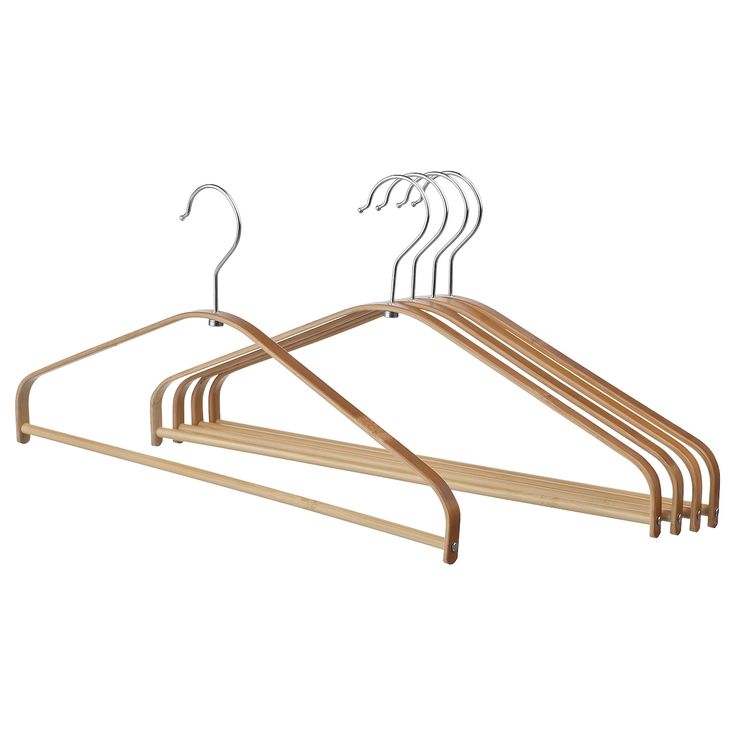 a wooden hanger with four pairs of clothes on it