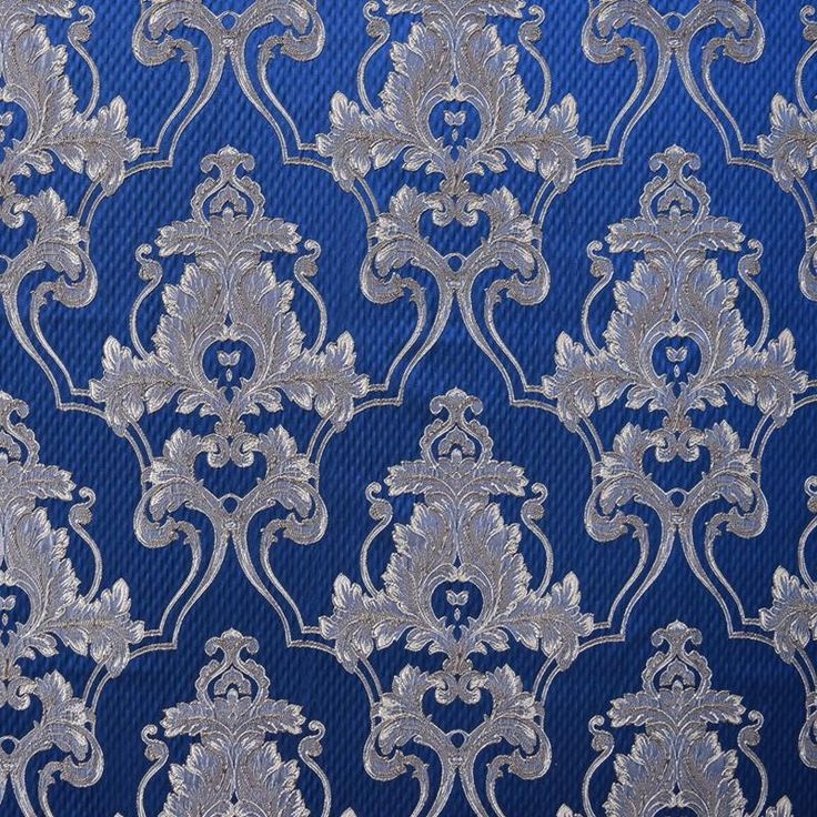 the blue and silver fabric has an intricate design on it