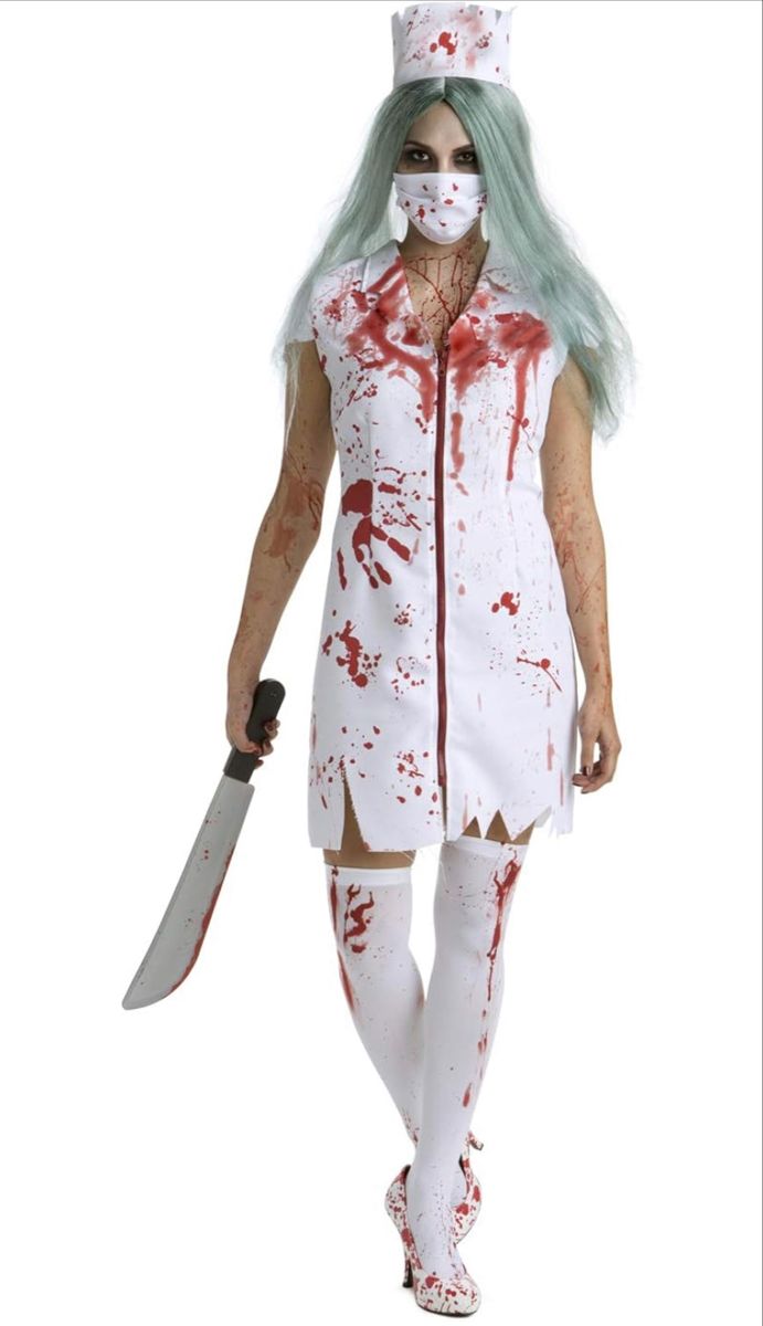 a woman dressed in a zombie costume holding a knife and wearing a white dress with green hair