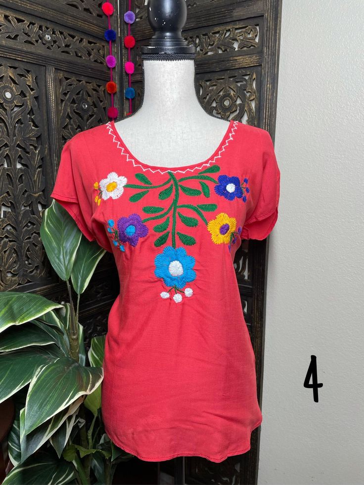 "A very nice and beautiful Sunflower Blouse w/Gorgeous Embroidery. The design work is simply gorgeous. Perfect for your ultimate weekend look, beach, casual look or just to impress your friends with this gorgeous piece. You will Love it! Blouse STYLE DETAILS Overview * Round neck * Handmade work * 3/4 Long sleeves * 22\" UNDERARM TO UNDERARM, 30.5\" SHOULDER TO HEM fabric & care * hand wash * delicate care * hang dry Please email me your questions before buying email me TODAY All of my items Summer Beach Blouse With Crew Neck, Summer Crew Neck Blouse For Beach, Summer Crew Neck Blouse For The Beach, Spring Crew Neck Blouse For Beach, Summer Blouse With Floral Embroidery And Short Sleeves, Red Bohemian Crew Neck Blouse, Red Summer Crew Neck Blouse, Red Crew Neck Blouse For Summer, Vacation Tops With Multicolor Floral Embroidery