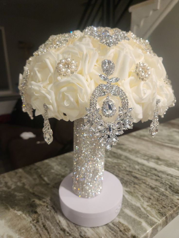 a bridal bouquet with white roses and crystals