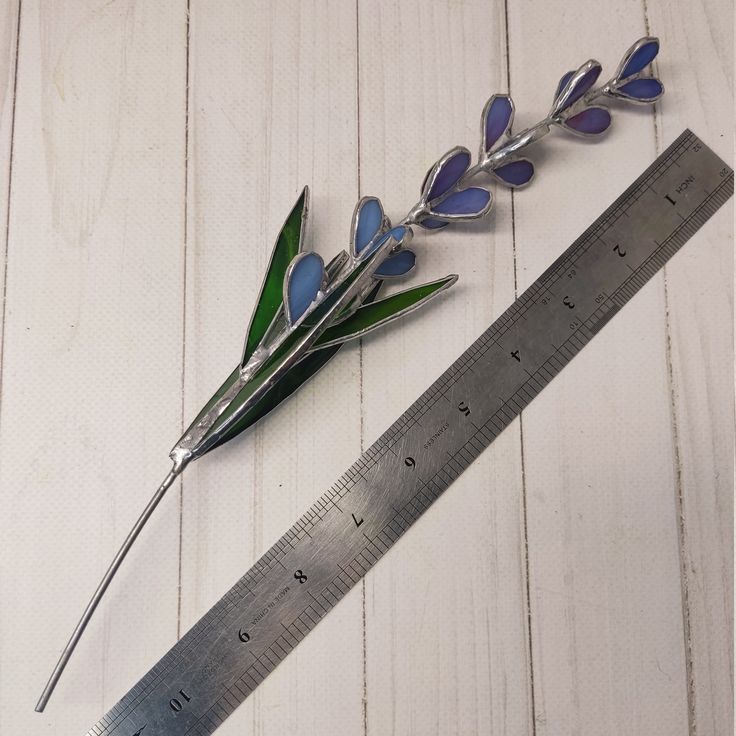 a ruler and some flowers on a table