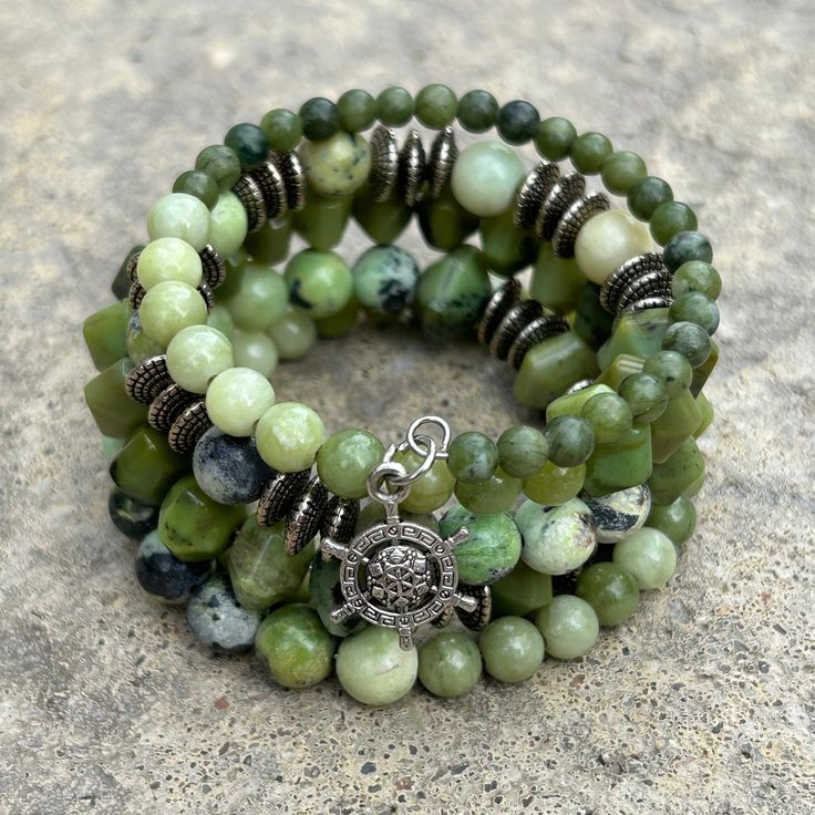 Shades of green and silver come together on this tone on tone beaded boho wrap bracelet. Faceted serpentine, round jade and chrysoprase are accented with silver disc spacers. 4mm round jade 6mm round jade 6x8mm faceted serpentine 8mm Chrysoprase one size fits most - best for small to medium wrists Handmade in Lincoln, Nebraska Green Gemstone Beads Bohemian Wrap Bracelet, Green Bohemian Wrap Bracelet With Gemstone Beads, Bohemian Green Wrap Bracelet With Gemstone Beads, Bohemian Green Gemstone Beads Wrap Bracelet, Green Bohemian Wrap Bracelet With Round Beads, Bohemian Green Wrap Bracelet With Round Beads, Bohemian Jade Bracelets, Green Hand-strung Spiritual Wrap Bracelet, Bohemian Green Wrap Bracelet With Natural Stones