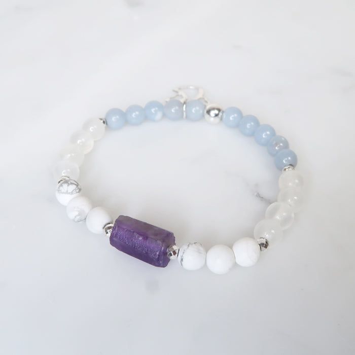 This bracelet was made to help you connect with your angels and guides and to remind you that they are always by your side. Crafted with AAA Grade 6mm Angelite, Selenite, Howlite, Amethyst, Hematite and accessorized with a silver Angel Charm to facilitate the connection between you and your Angels & Guides. Stone Details Angelite enhances communication with Angels and higher beings of light. It helps to amplify your telepathic connection with angels as it works to send out and receive messages. Spiritual Healing Crystal Bracelet With Spacer Beads, White Spiritual Charm Bracelet For Friendship, White Amethyst Gemstone Beaded Bracelets, White Amethyst Beaded Gemstone Bracelets, White Amethyst Spiritual Beaded Bracelets, White Amethyst Beaded Bracelets For Spiritual Style, White Spiritual Bracelets For Healing, White Amethyst Beaded Bracelet As Gift, White Amethyst Beaded Bracelets As Gift