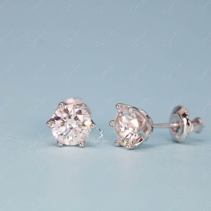 These simple yet stunning Moissanite stud earrings from The Silver Luna are the perfect diamond alternative gift. Moissanite gemstones sparkle with more fire and brilliance than mined diamonds, but at a fraction of the cost. Each earring features a 0. or 1 carat equivalent Moissanite gemstone set on solid 925 sterling silver bases. Whether you're shopping for an engagement gift, anniversary present or just looking to treat yourself, these Moissanite earrings provide dazzling beauty and lasting v Silver Single Diamond Earrings Fine Jewelry, Solitaire Diamond White Diamond Earrings, Diamond White Solitaire Diamond Earrings, Diamond Cut Diamond Earrings, Gift Moissanite Earrings With Round Cut, Moissanite Round Cut Earrings For Gift, Gift Silver Brilliant Cut Diamond Earrings, Silver Brilliant Cut Diamond Earrings As Gift, Silver Brilliant Cut Diamond Earrings For Gift