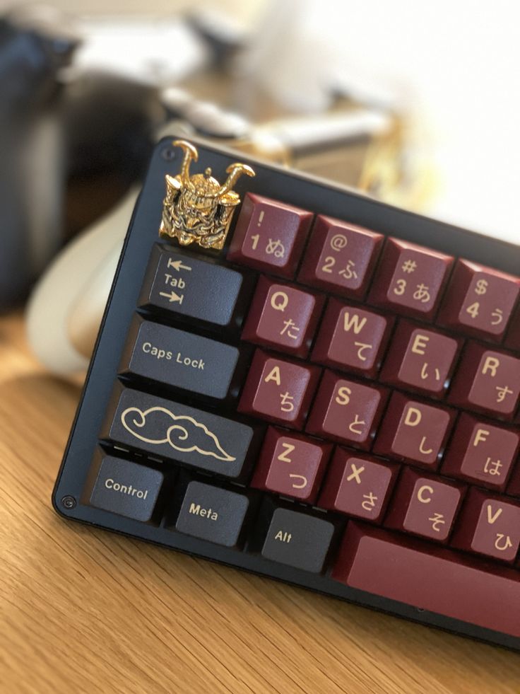 a computer keyboard sitting on top of a wooden desk