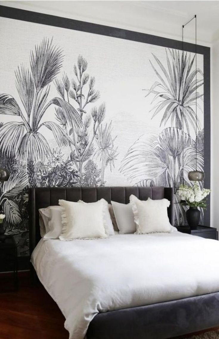 a bedroom with a large wall mural behind the bed and pillows on the headboard