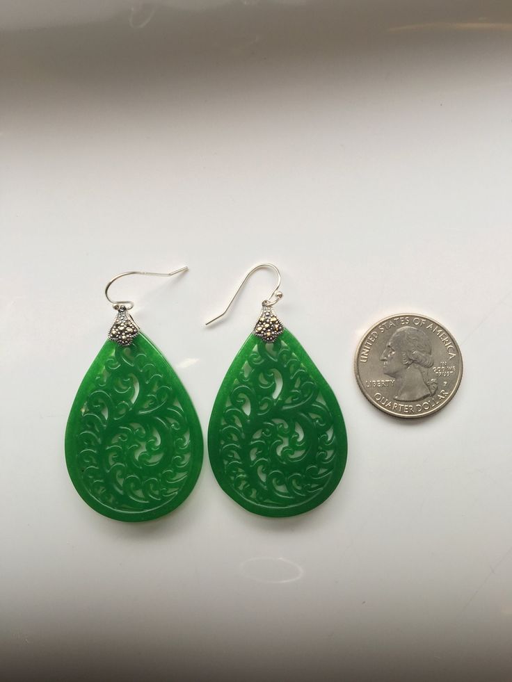 A pair of vintage green carved jade earrings comes with 925 sterling silver hooks. The big emerald-like green jade drops are heavy duty and being carved into full delicate tree/leaf details. The laced teardrop designs bring you a taste of ancient Chinese royal feel. Some highlights of this elegant and fancy dangle silver jade earrings are: *High-quality materials Quality green jade, delicate carving details, 925 sterling silver. Makes perfect gift for yourself or friends. *Vintage Chinese style Green Jade Earrings For Pierced Ears, Traditional Jade Drop Earrings, Green Teardrop Pierced Earrings For Gift, Green Teardrop Pierced Earrings As A Gift, Green Oval Hypoallergenic Earrings, Hypoallergenic Green Oval Earrings, Vintage Green Jade Earrings, Traditional Pierced Jade Earrings, Nickel-free Teardrop Jade Earrings