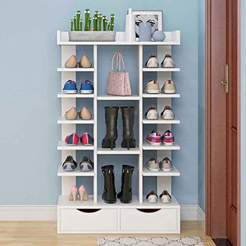 a white shelf filled with lots of pairs of shoes next to a blue painted wall