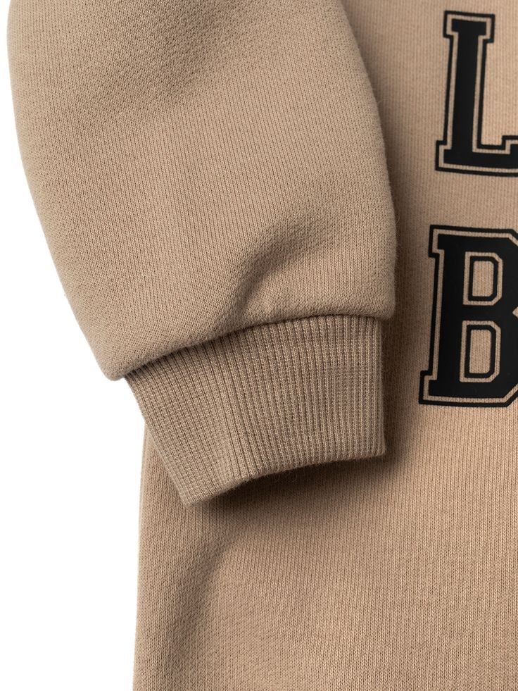 Calling all LB superfans! The most stylish way to show your LB pride is our Collegiate Crewneck, featuring classic “Little Bipsy” text + the familiar, cozy feel of your favorite college sweatshirt. Pair it with our Gym Short or Athletic Ribbed Biker Short to rep LB from head to toe! Color: Tan “LITTLE BIPSY” printed on the front Ribbed neckline, cuffs, and bottom hem Rollable + cinched wrist cuffs Material + Wash 86.7% cotton | 13.3% polyester Do not bleach Machine wash cold with like colors Dry Winter Sweatshirt With Letter Patch Long Sleeve, Collegiate Winter Sweats For Loungewear, Winter Crew Neck Top With Letter Patch, Collegiate Letter Print Sweatshirt For Loungewear, Game Day Long Sleeve Letter Print Sweater, Sporty Fall Sweater For School, Casual School Sweater With Letter Print, Basic Letter Print Sweats For Fall, Winter School Sweater With Letter Print