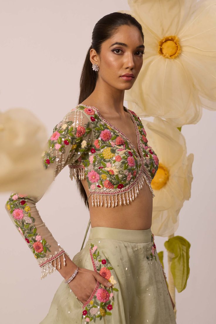 A burst of freshness - that's what this lupin pistachio green lehenga set is all about! Paired with multicolor resham embroidered full sleeves blouse in a monochrome shade, it is the ultimate bridesmaids's dream. The skirt, crafted in organza, features intricate embroidery on circumference part of the lehenga, and is perfect for twirl-ready moments. Also featuring a organza dupatta with the same to go all out with it Green Embroidered Party Wear Dupatta, Pista Green Choli With Floral Embroidery For Party, Green Floral Embroidery Anarkali Set For Party, Green Hand Embellished Anarkali Set, Pista Green Anarkali Set With Floral Embroidery For Party, Hand Embellished Green Anarkali Set, Green Hand Embellished Traditional Sharara, Green Designer Party Wear Sets, Festive Green Hand Embellished Choli