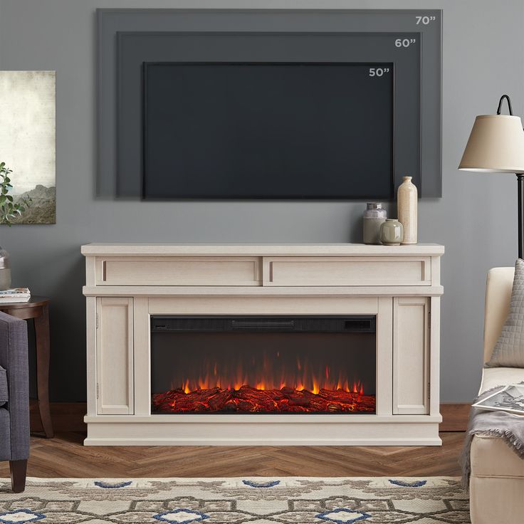 a living room with a fireplace and tv on the wall, in front of a couch