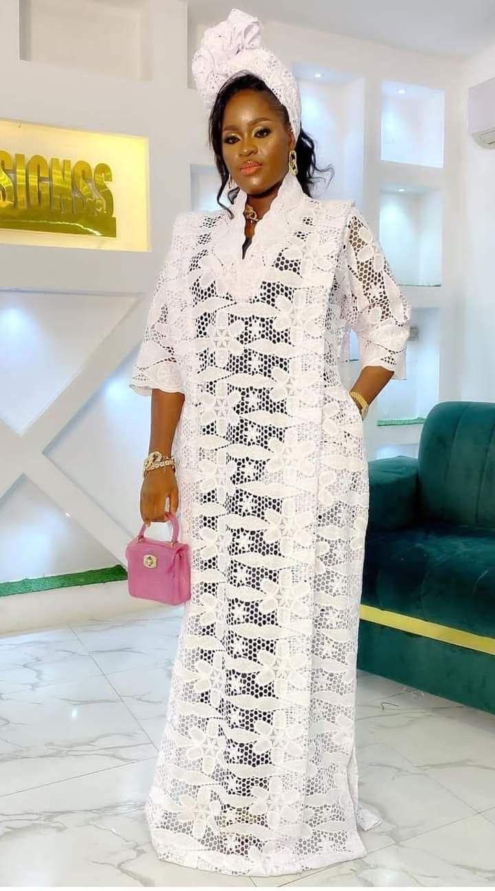 Whiter lace kaftan Bubu Styles Lace, Lace Kaftan Dress Nigeria, Elegant White V-neck Kaftan, Lace Boubou Gown Style, Elegant White Maxi Dress With Lace Work, White Fitted Kaftan For Party, Fitted White Kaftan For Party, White Maxi Length Lace Dress, Elegant White Crochet Lace Maxi Dress