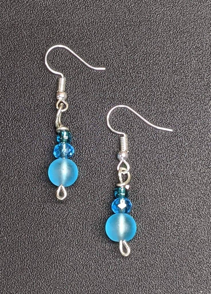 Fun and funky fierce and fabulous earrings made in Hawaii. Earrings with blue glass beads. Fun Handmade Blue Jewelry, Light Blue Beaded Dangle Earrings For Party, Nickel Free Czech Glass Beaded Earrings For Party, Blue Hypoallergenic Party Earrings, Hypoallergenic Blue Earrings For Party, Blue Party Earrings With Ear Wire, Blue Dangling Beads Earrings For Party, Blue Round Beads Earrings For Jewelry Making, Blue Adjustable Beaded Earrings For Pierced Ears