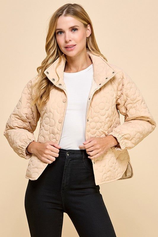 This cute beige jacket boasts a charming floral quilted pattern and playful button down style. Stay cozy and stylish in this unique piece! Fit: True to size. Fabric: 100% polyester Quilted Button-up Winter Outerwear, Cozy Beige Outerwear With Button Closure, Cream Quilted Long Sleeve Outerwear, Cozy Cream Button-up Outerwear, Cream Quilted Long Sleeve Jacket With Pockets, Cream Long Sleeve Quilted Jacket With Pockets, Cream Quilted Winter Outerwear, Cream Quilted Puffer Jacket For Winter, Winter Cream Quilted Puffer Jacket