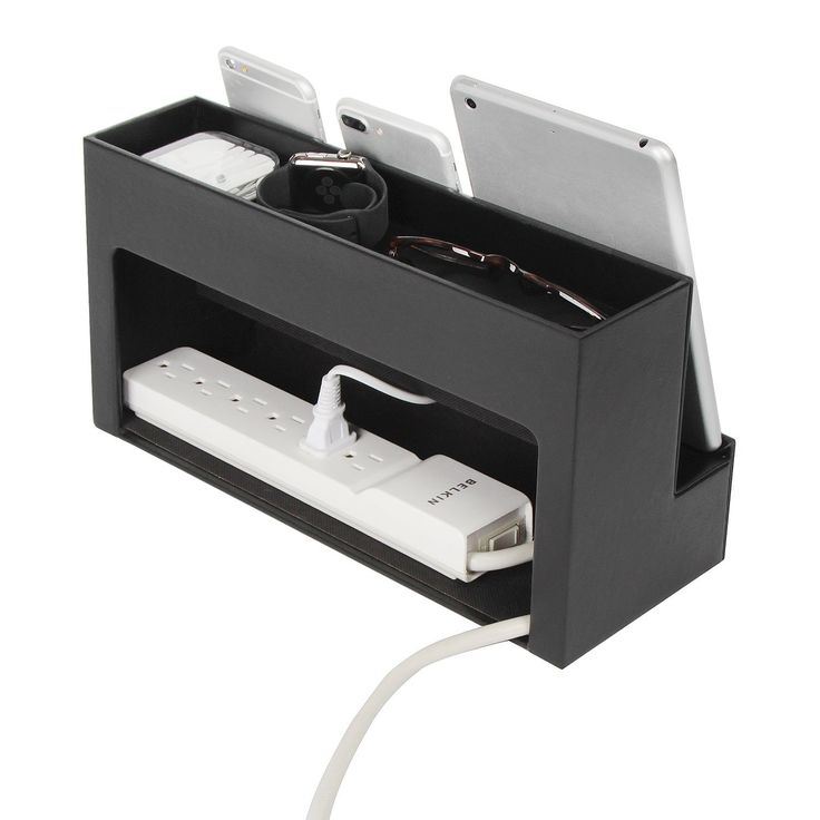 an electronic device charging station attached to a charger with two phones and cords in it