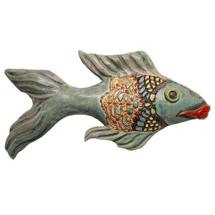 a ceramic fish with multicolored designs on it's body and head, sitting in front of a white background