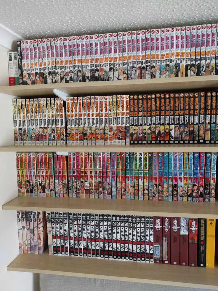 a book shelf filled with lots of books on top of wooden shelves next to a white wall