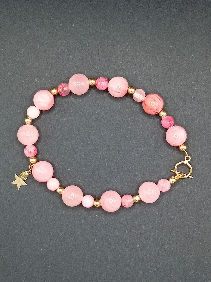 If your into pink then this one's for you! 14k gold filled bracelet made with genuine pink jade gemstones and finished with a gold star . Dainty Pink Beaded Bracelets With Gemstone Beads, Dainty Pink Round Bracelet, Dainty Pink Rose Quartz Beaded Bracelets, Dainty Pink Rose Quartz Beaded Bracelet, Pink Gemstone Beads Charm Bracelet, Adjustable Pink Beaded Bracelets In 14k Gold, Pink Opal Round Beads Bracelet, Dainty Pink Jewelry With Gemstone Beads, Pink Bracelets With Natural Stones And Round Beads