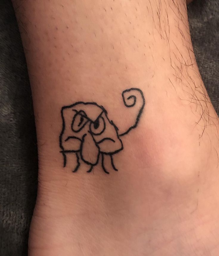 a small tattoo on the foot of a person