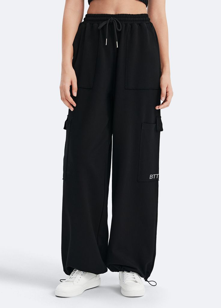 Embrace roomy wide legs and a stretchy fit for ultimate comfort, paired with a flattering high waist for added style. Whether it's grocery runs, lazy Sundays, or a casual hangout, these joggers have you covered in relaxed elegance. Black Wide Leg Pants With Drawstring, Sporty Black Wide Leg Pants With Pockets, Casual Oversized Black Wide Leg Pants, Casual Black Drawstring Wide Leg Pants, Casual Black Wide Leg Pants With Drawstring, Relaxed Fit Wide Leg Streetwear Pants With Elastic Waistband, Sporty Baggy Wide Leg Pants, Comfortable Oversized Bottoms For Streetwear, Sporty Black Wide Leg Pants