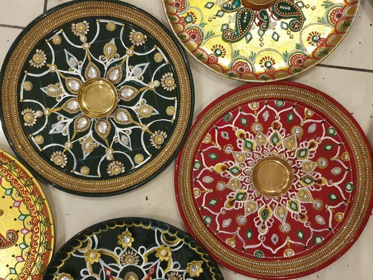 four decorative plates are on the floor