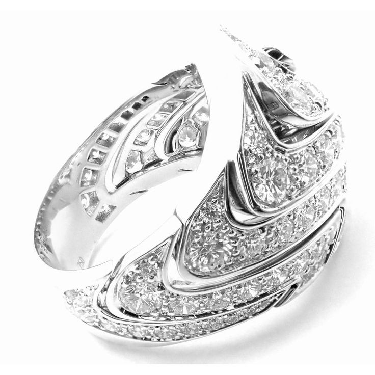 Authentic Cartier 18k White Gold Diamond Waves Large Ring  This ring comes with original Cartier box.   Metal: 18k White Gold Ring  Size: European 58, US 8 1/4  Stones: 86 Round brilliant cut diamonds VVS1 clarity, E color total weight approximately 4.30ct  Weight: 26.2 grams  Width: 22mm  Hallmarks: Cartier 750 58 292XXX(serial number omitted) French Hallmarks  Dimensions reference the ring size and are not specific to the ring itself. Luxury Cartier Ring With Brilliant Cut, Luxury Cartier Diamond Ring With Vvs Clarity, Luxury Cartier Brilliant Cut Rings, Classic Cartier Diamond Ring With Pave Setting, Cartier Cubic Zirconia Ring, Cartier Diamond Ring With Single Cut Diamonds, Cartier Jewelry With Pave Setting In Round Cut, Luxury Cartier Rings With Diamond Accents, Cartier Round Cut Jewelry With Pave Setting