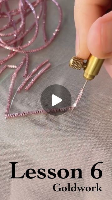 someone is working with some thread on a piece of fabric and the words lesson 6 goldwork