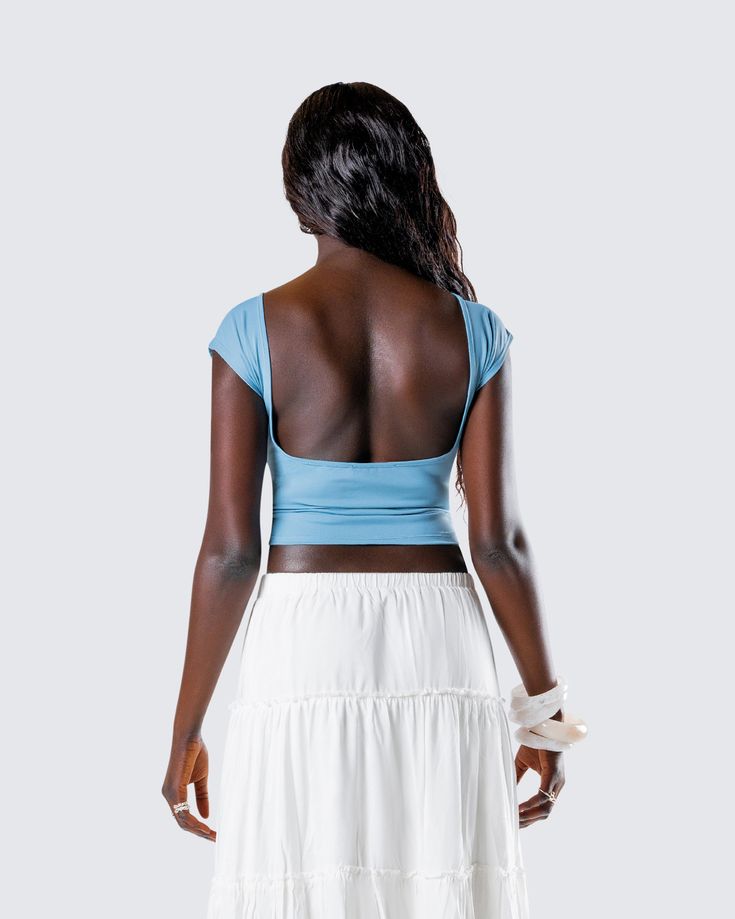 Sleek in the front, sexy in the back 💙 Made from jersey fabric, complete with a cap sleeve, regular length, low open back, and form-fitting style - this blue backless top is perfect for casual days, nights out, and everything in between 😍 Fitted Seamless Blue Top, Solid Top With Built-in Bra And Scoop Back, Fitted Crop Top With Built-in Bra And Scoop Back, Fitted Backless Beach Top, Blue Fitted Elastane Top, Fitted Blue Elastane Top, Blue Fitted Stretchy Crop Top, Light Blue Fitted Seamless Crop Top, Fitted Light Blue Seamless Crop Top